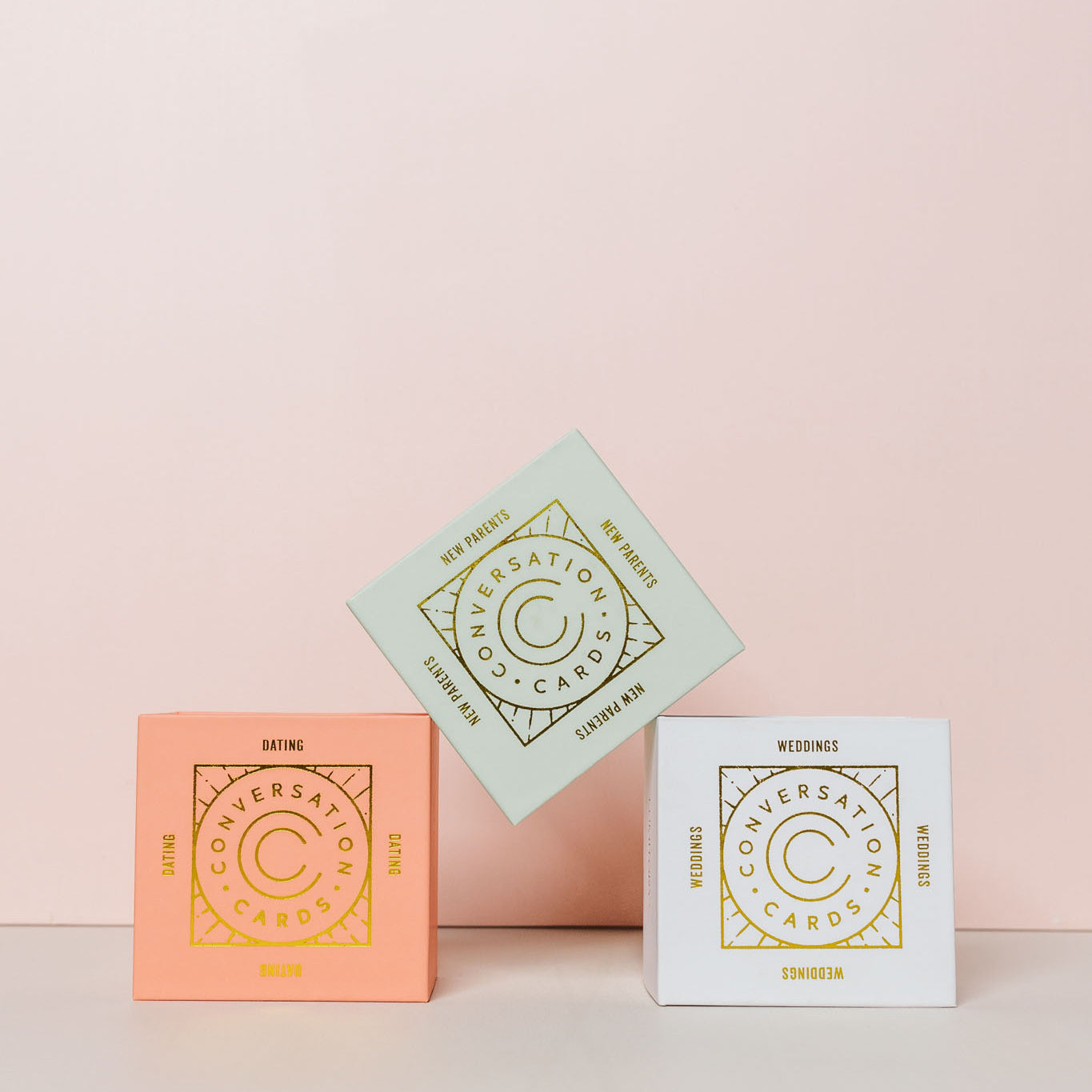 Conversation cards stacked on a pink background