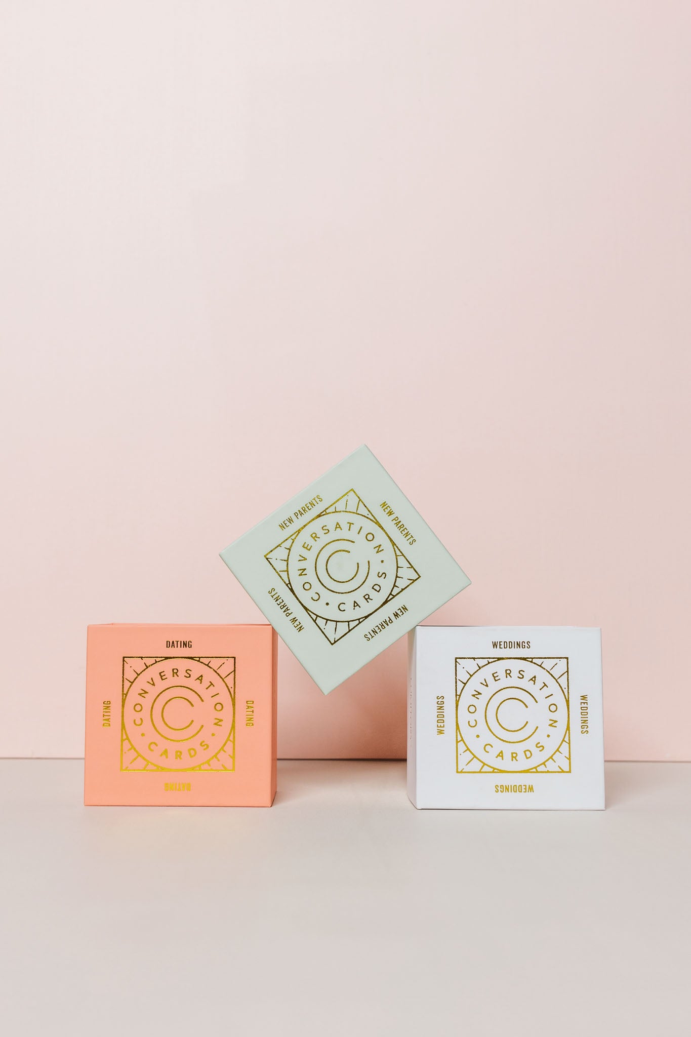 Conversation cards stacked on a pink background