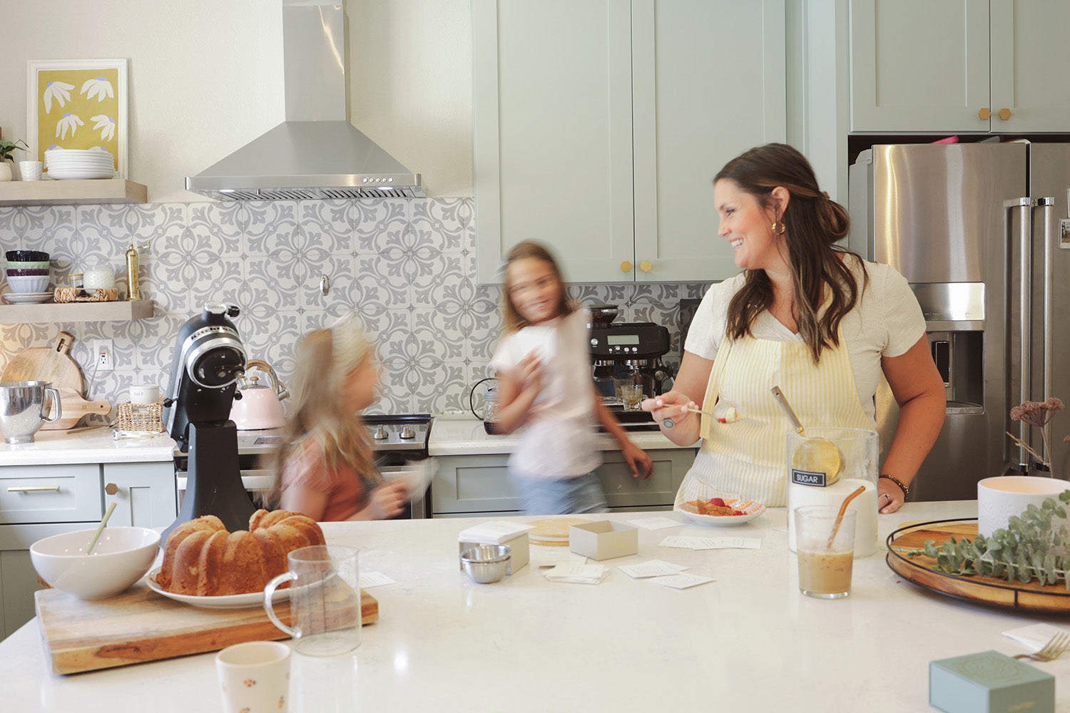 Young family in the kitchen baking together and reading conversation cards from Lumitory.